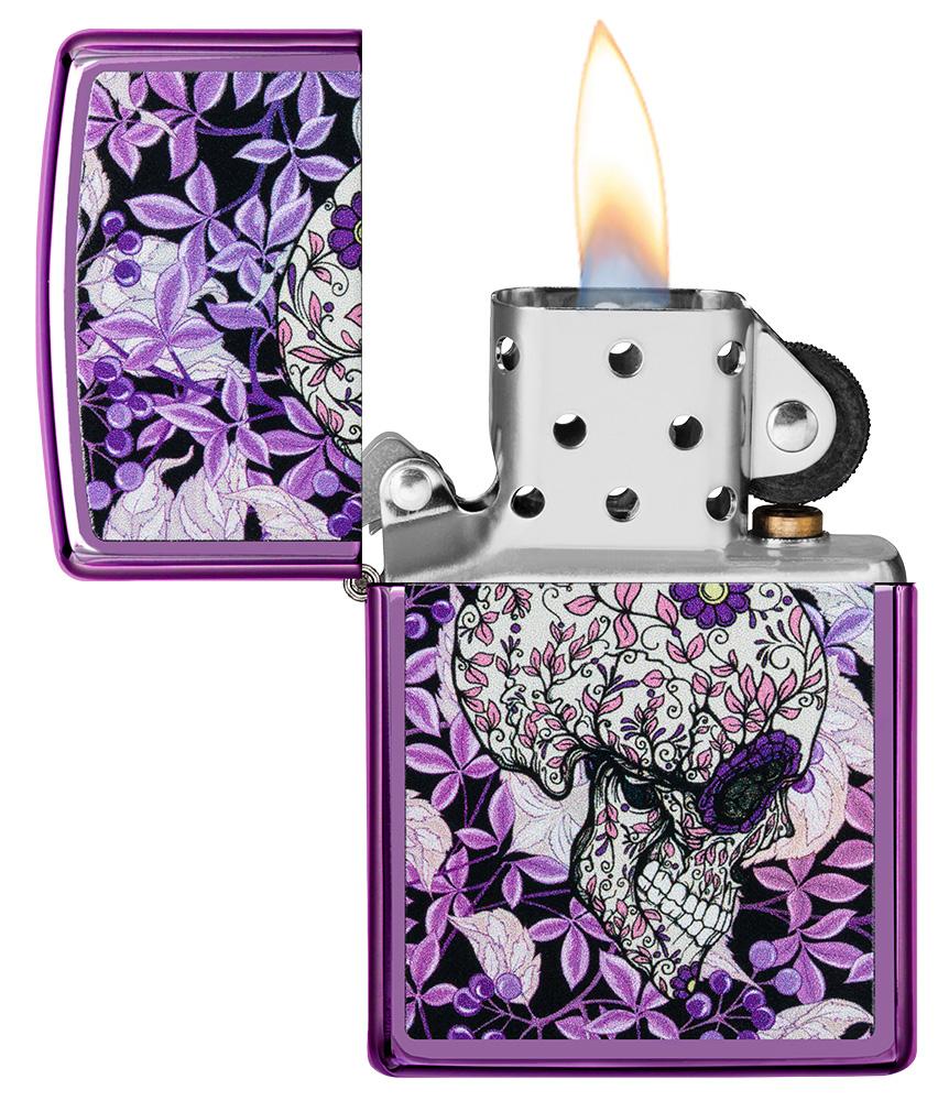 Hidden Skull High Polish Purple windproof lighter with its lid open and lit