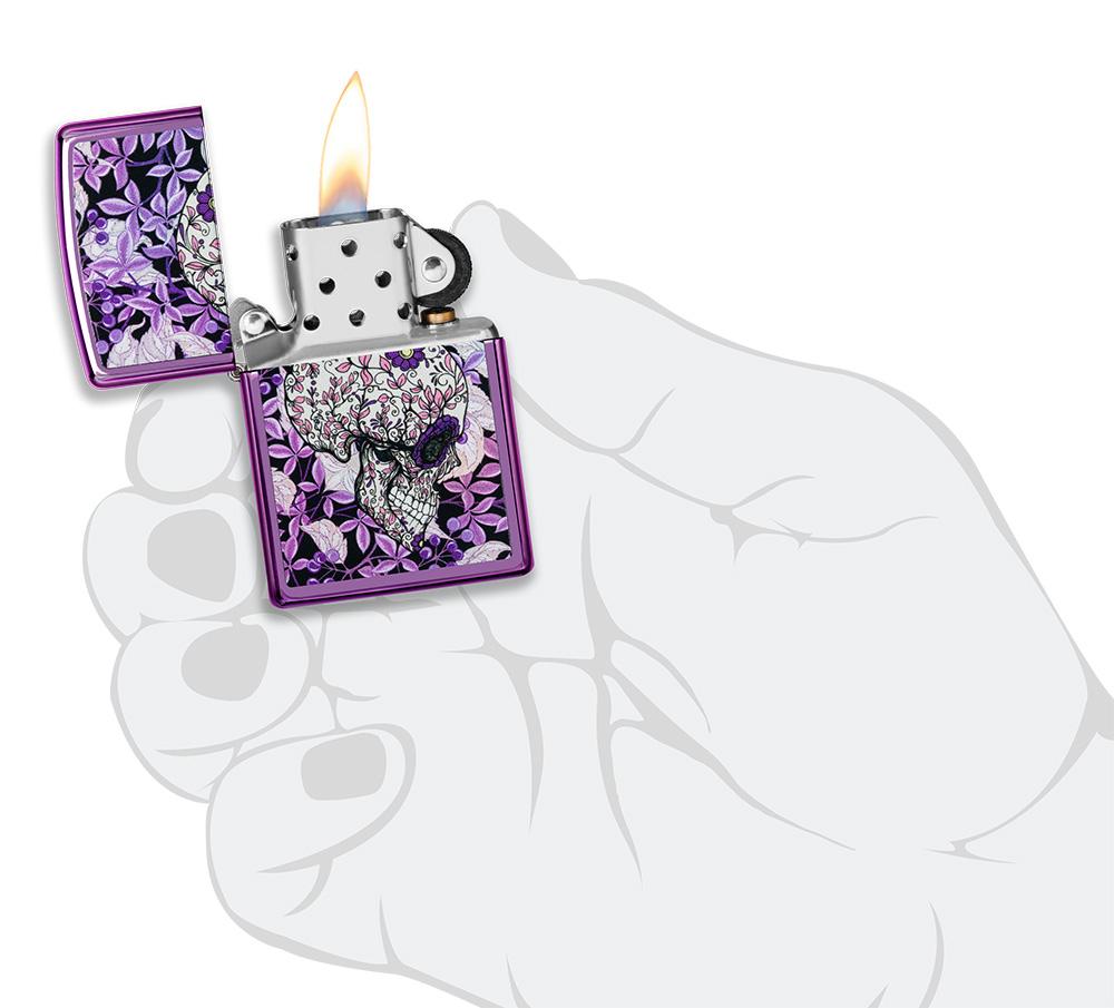 Hidden Skull High Polish Purple windproof lighter lit in hand
