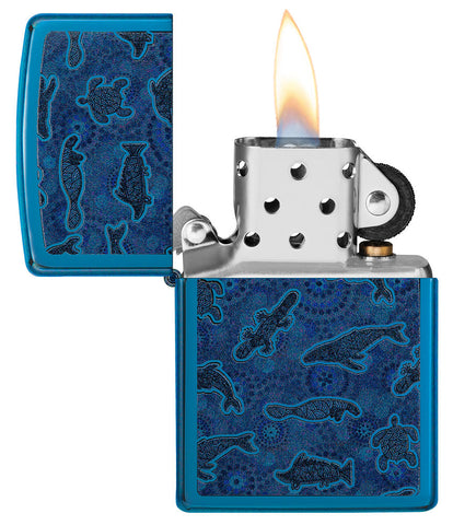 Zippo lighter front view opened and lit in high gloss blue with illustration of sea creatures in the style of Aboriginal art.