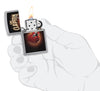 Zippo lighter front view chrome open and lit with coloured image of a red guitar of Eric Clapton in stylistic hand