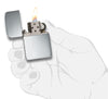 Zippo Lighter 1941 Replica in sterling silver front view opened and lighted in high polished silver optic in stylized hand