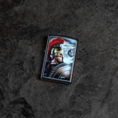 Lifestyle image of Mazzi Spartan Warrior and Lion Lighter laying on dark background