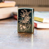 Lifestyle image of Botanical Design High Polish Green Windproof Lighter standing on a desk with books in the background