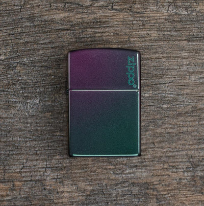 Lifestyle image of Iridescent Zippo Logo Windproof Lighter laying flat on a wooden surface