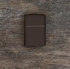 Lifestyle image of Brown Windproof Lighter laying flat on a wooden surface