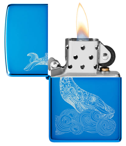 Zippo Lighter Front View Whale Design shiny light blue with an engraved whale with round waves Opened and Lit